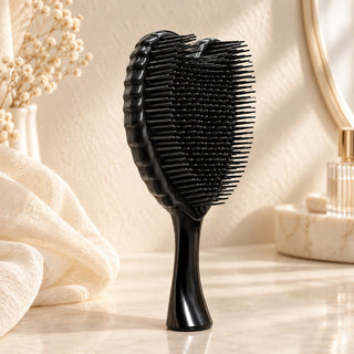 Black Angel Hairbrush standing on a bathroom counter