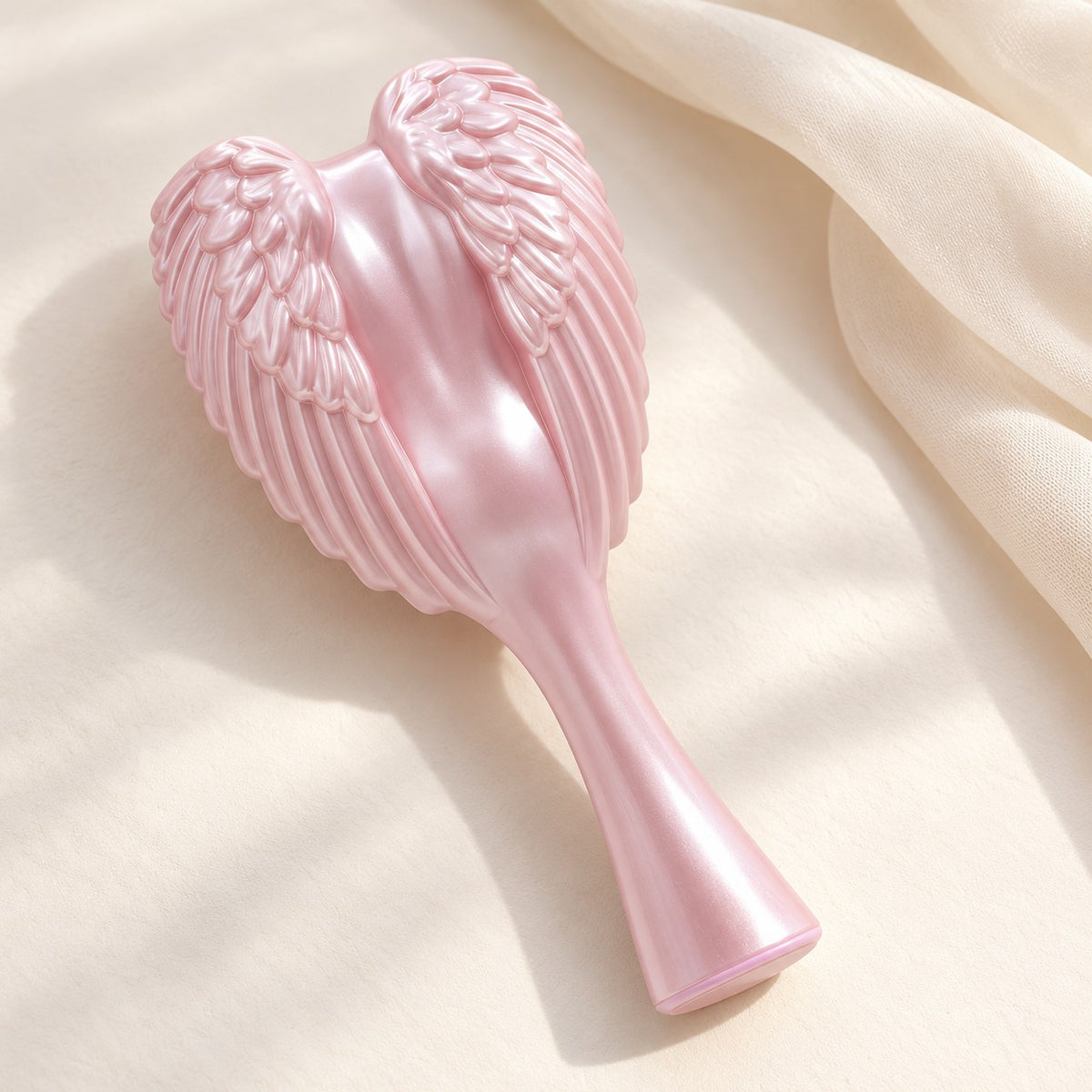 Pink Angel Hairbrush with pearly sculpted angel wings on cream silk