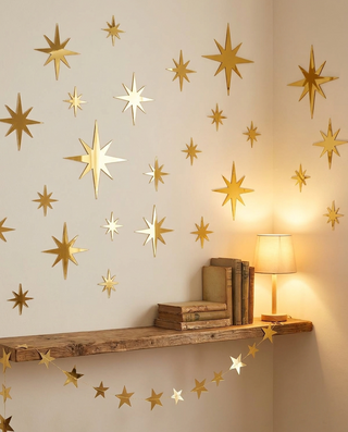 Gold mirror star stickers with the Starlight Garland on a bedroom shelf