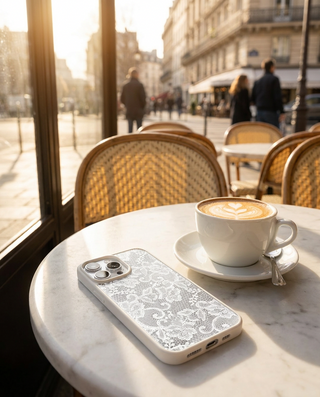 White Frame lace phone case in a sunny café